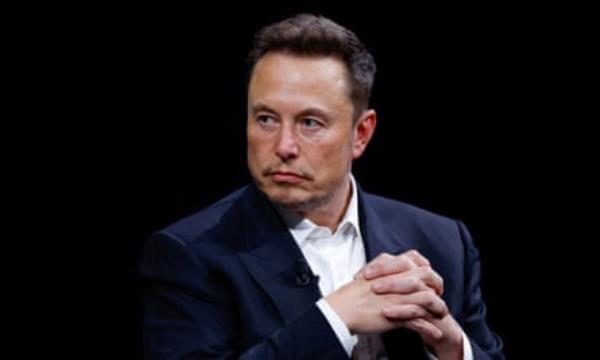 Elon Musk clasps his hands