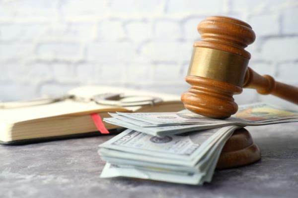 close up of gavel and cash on wooden background ,