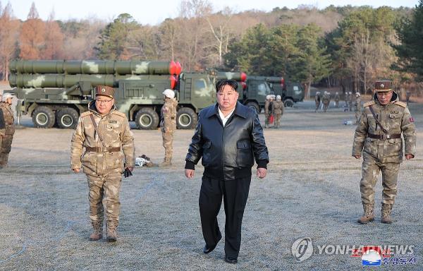 This photo, carried by North Korea's official Korean Central News Agency on March 19, 2024, shows the North's leader Kim Jong-un (C) guiding a 