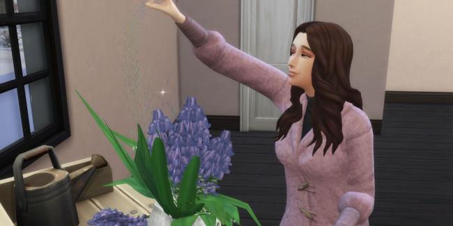 A female Sim sprinkles a sparkle-like dust on a flower arrangement in The Sims 4.