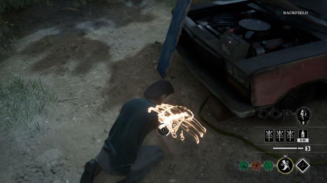 The Hitchhiker setting a trap near the car battery.