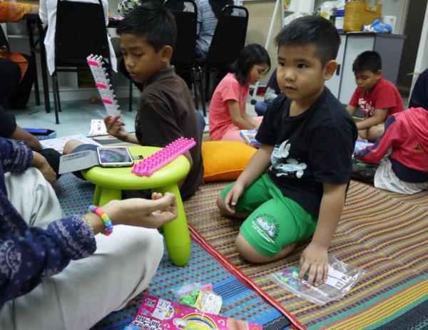 John (in green shorts) who was then five, followed his mum to volunteer at a resource centre for single mothers at Pantai Dalam. — Photos: LAM SWEE THEAM