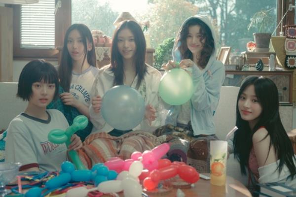 This image provided by ADOR is captured from the music video for K-pop girl group NewJeans' 