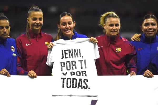 Players from Spain's Barcelona and Mexico's Club América teams hold a shirt Tuesday before a friendly match in Mexico City that translates to: