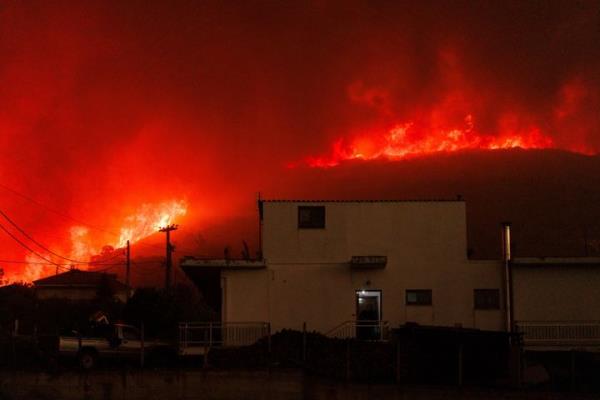A wildfire burns a forest near a house in Avantas village, near Alexandroupolis town, in the northeastern Evros region, Greece, on Aug. 21, 2023.