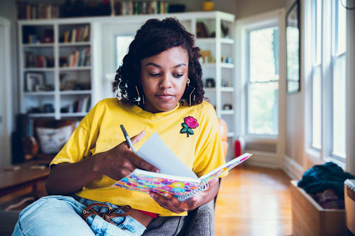 photo of a woman writing in a notebook